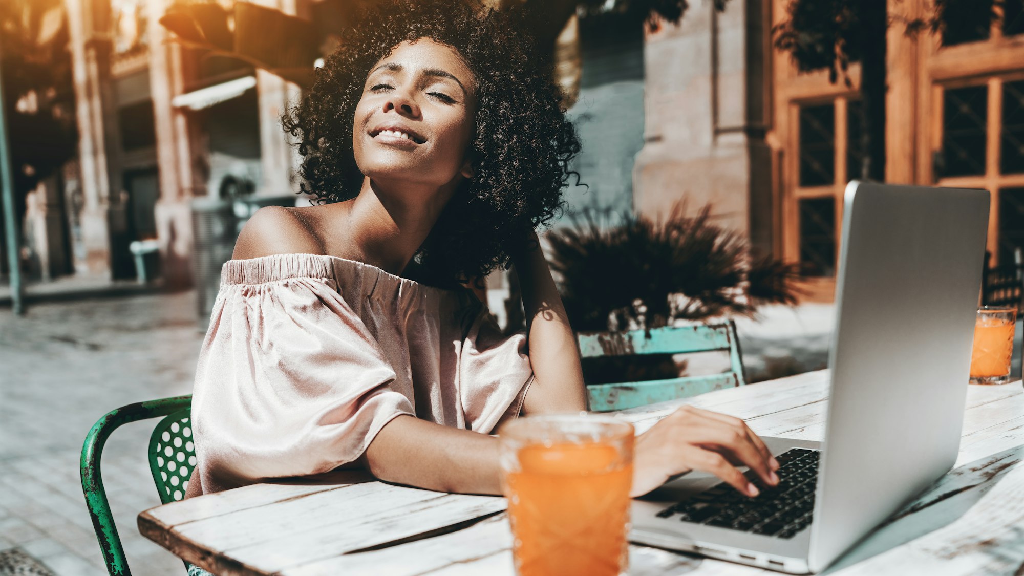 Biracial woman in cafe with laptop